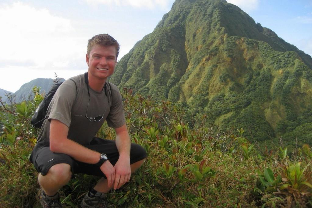 a student poses in front of a mountain in the dominican republic