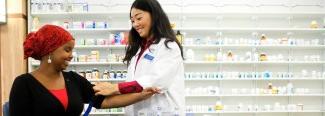 a pharmacy student takes a patient's blood pressure